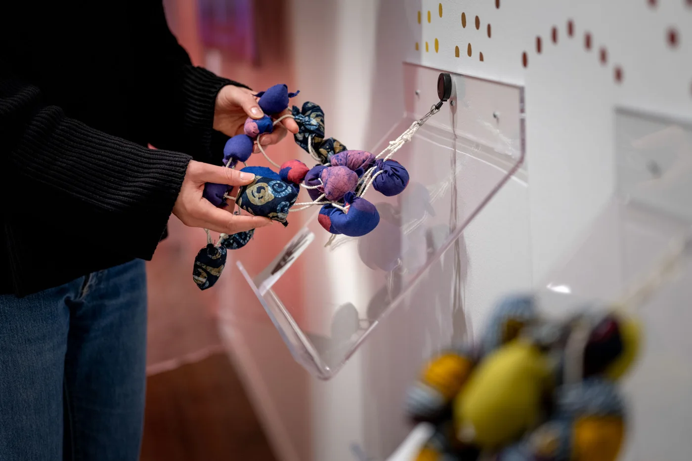 A visitor handling materials at the Textile Museum