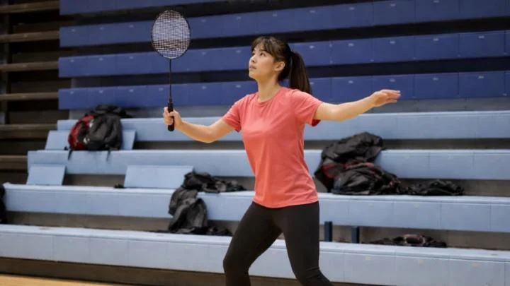 A badminton player serving at Toronto Pan Am Sports Centre