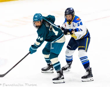 Lexie Adzija and Renata Fast competing for the puck