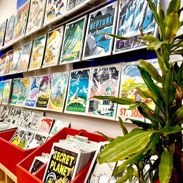 Prints and paper goods displayed along a wall at Secret Planet