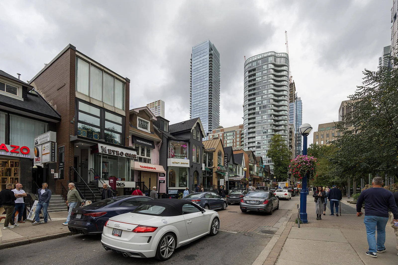People and shops on a Yorkville street in September 2026