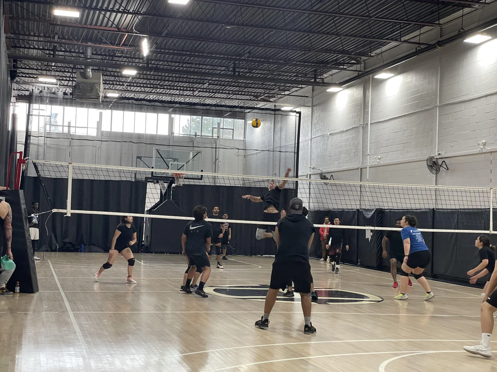 Players practising on an indoor volleyball court