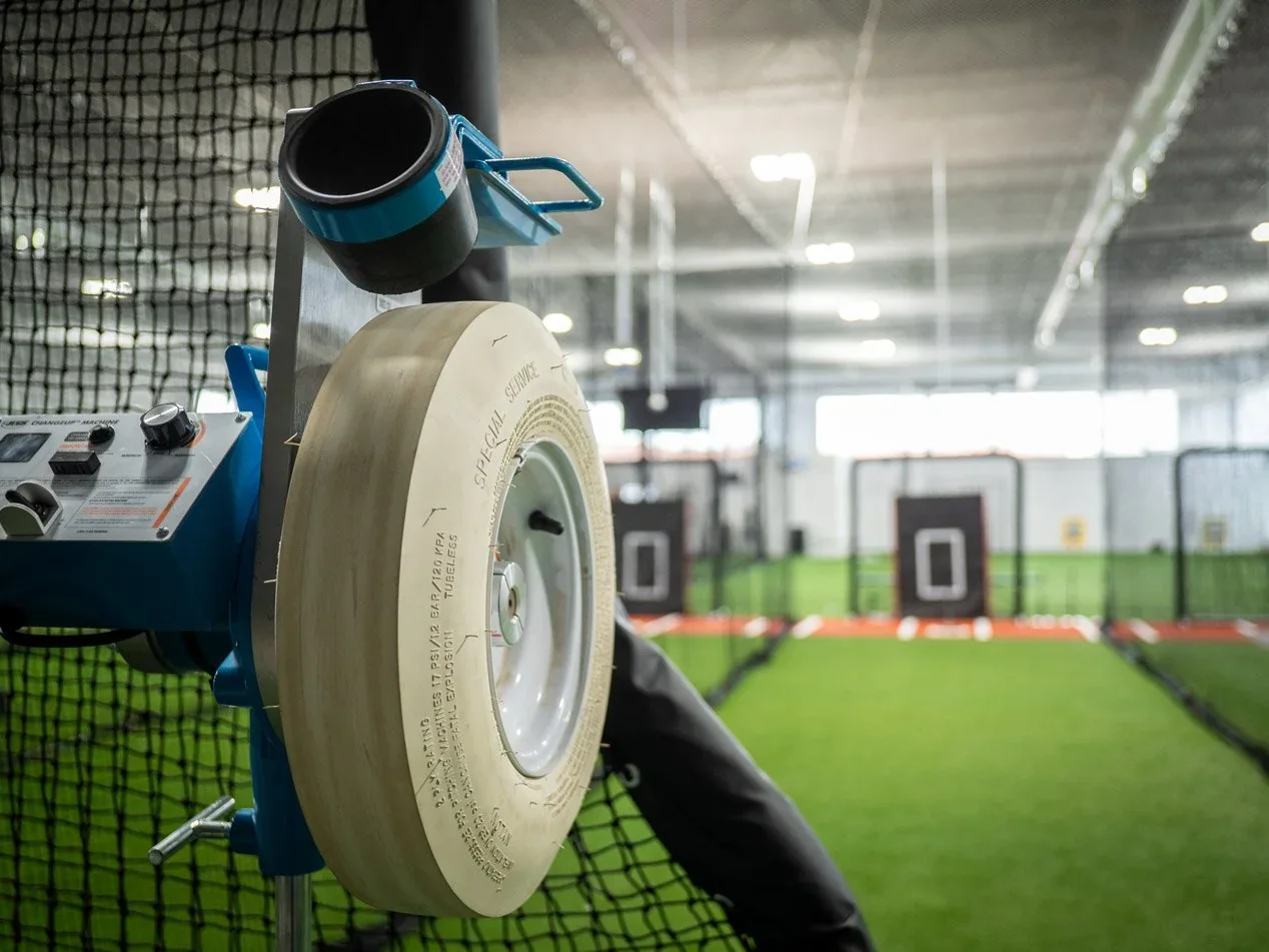 Close view of a pitching machine inside Athlete’s Turf