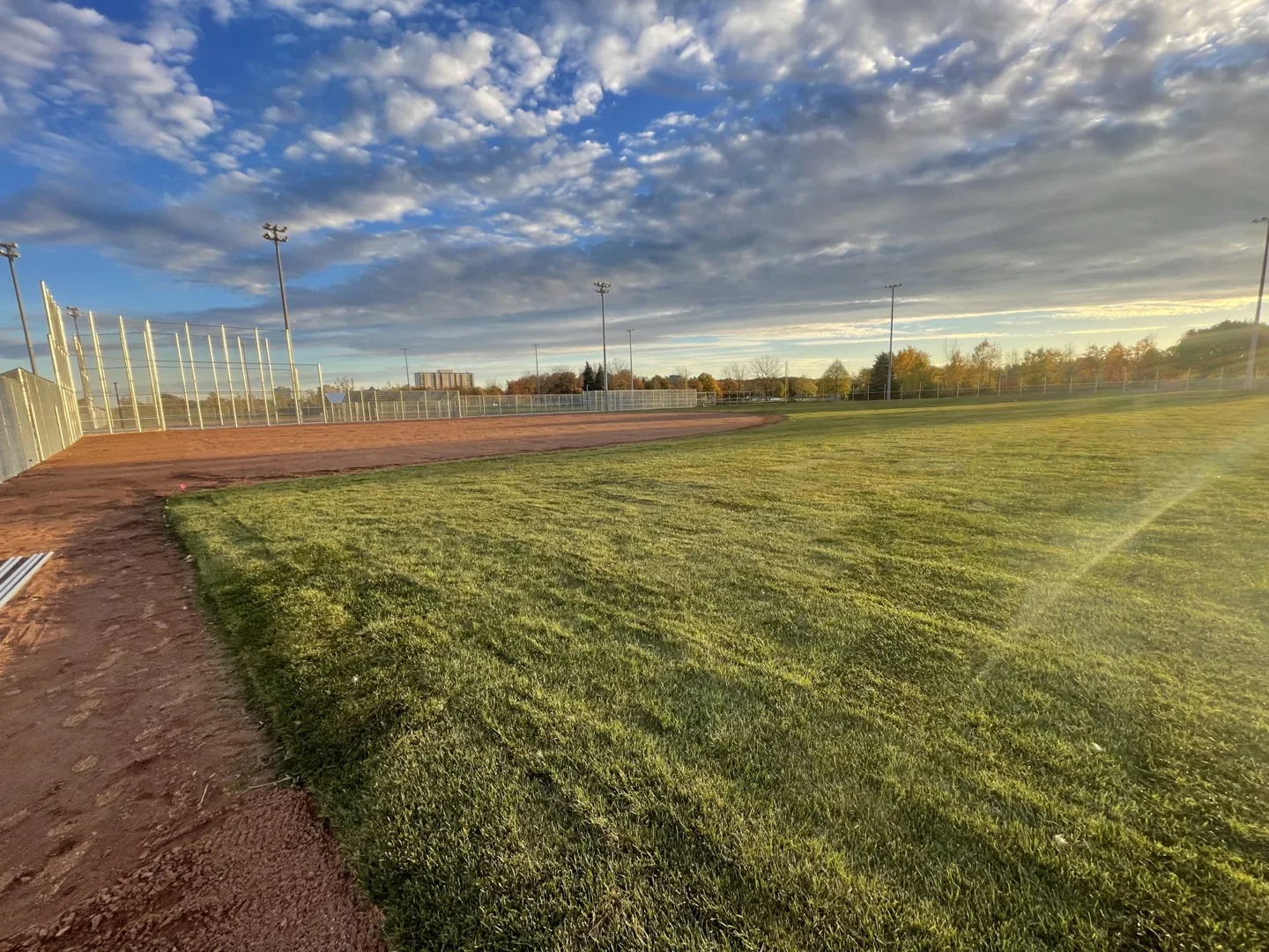 A completed baseball diamond at Centennial Park beneath tall lights