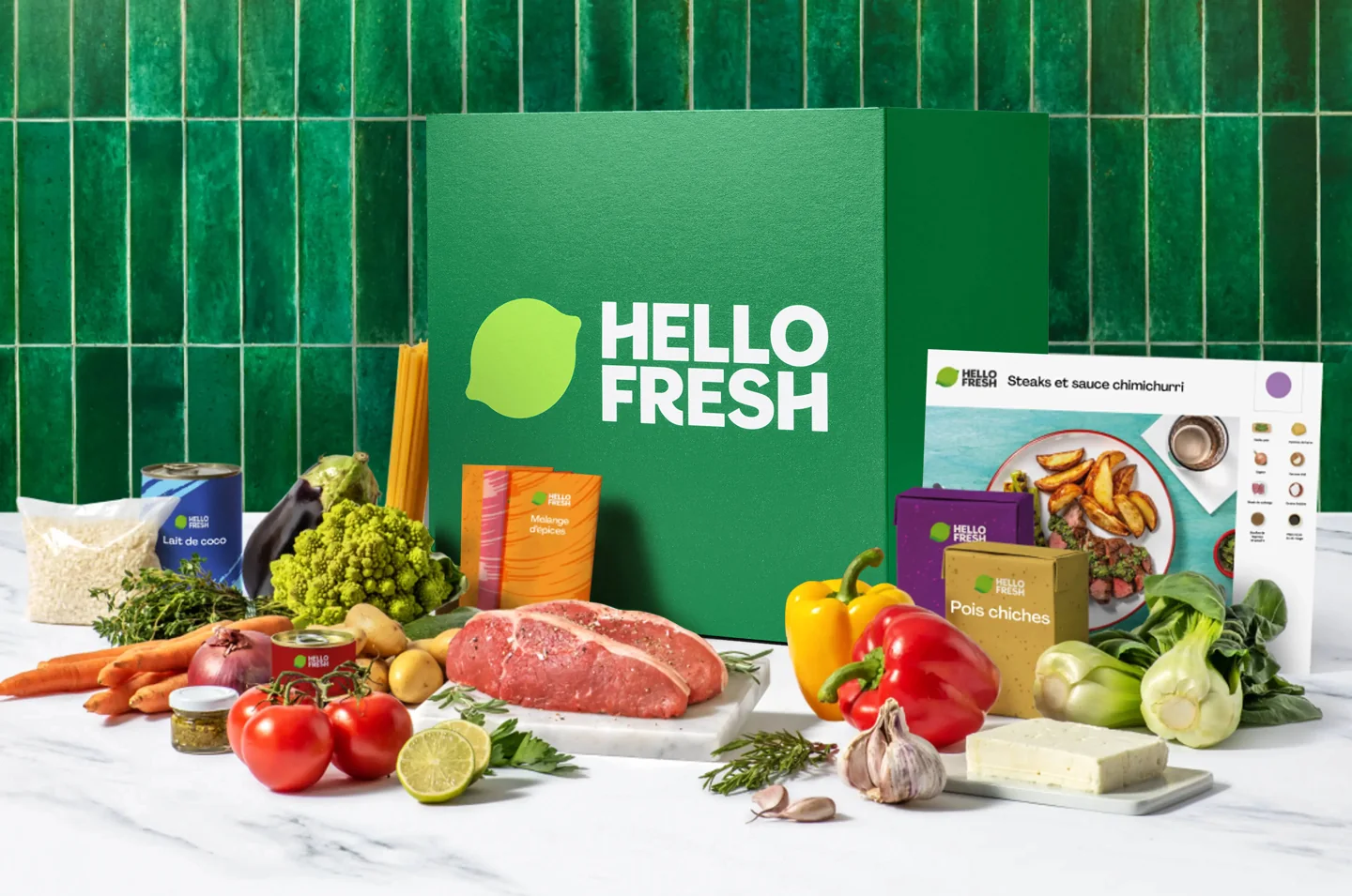 A HelloFresh box, recipe card and ingredients on a kitchen counter