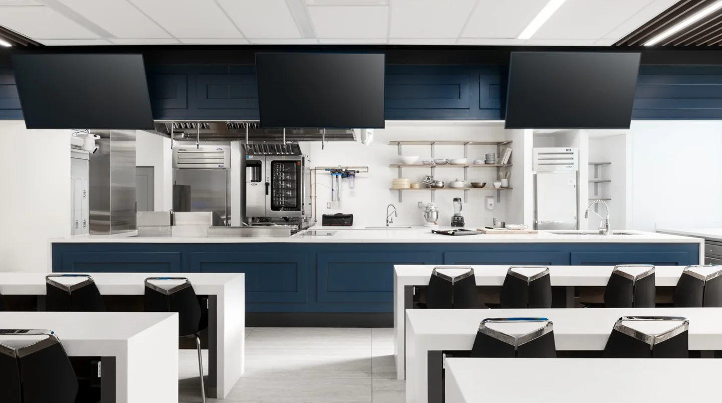 A George Brown demonstration kitchen with screens above the workbench