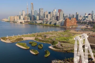 An aerial view of Biidaasige Park beside Toronto Harbour and the skyline