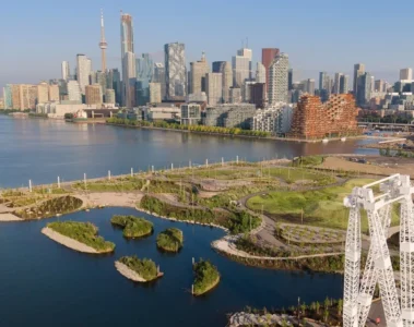 An aerial view of Biidaasige Park beside Toronto Harbour and the skyline