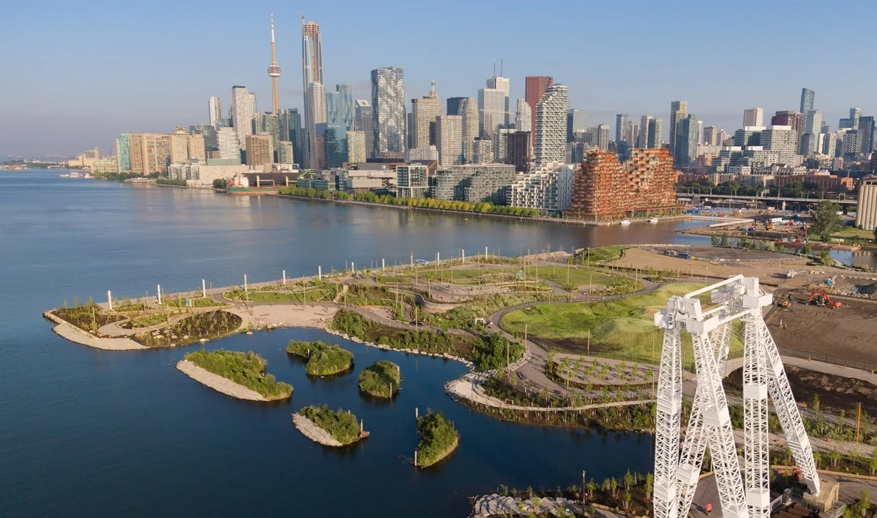 An aerial view of Biidaasige Park beside Toronto Harbour and the skyline