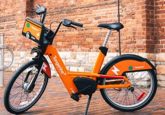 An orange Bike Share Toronto e-bike showing its thicker frame and rear battery housing