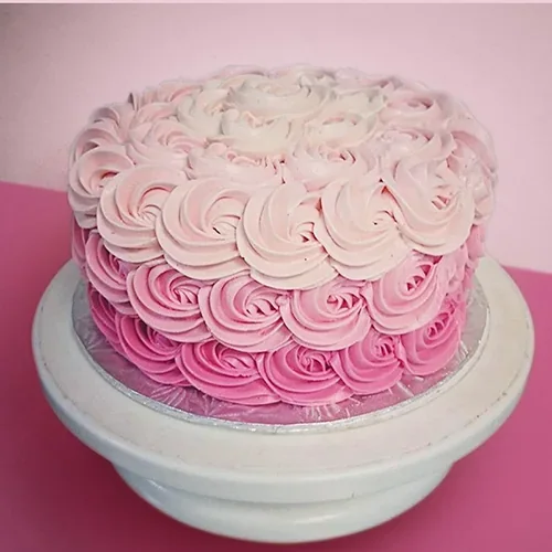 A pink cake with piped roses from The Cupcake Shoppe