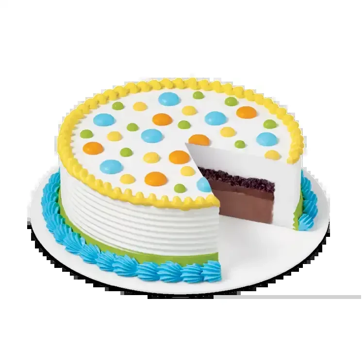 A round Dairy Queen cake with coloured dots and a slice removed