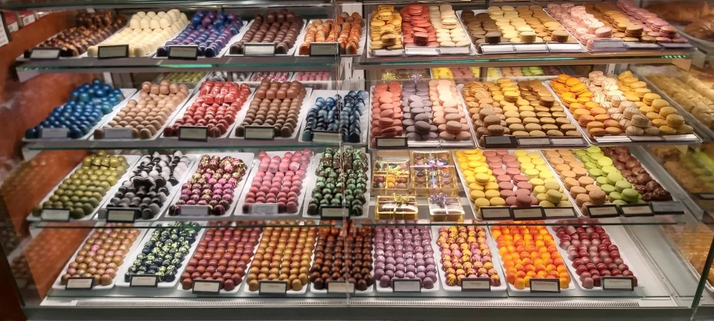 Rows of small desserts in Eve’s Temptations display case
