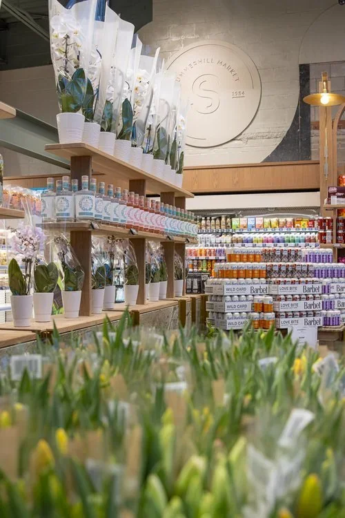 The floral and grocery area inside a Summerhill Market store