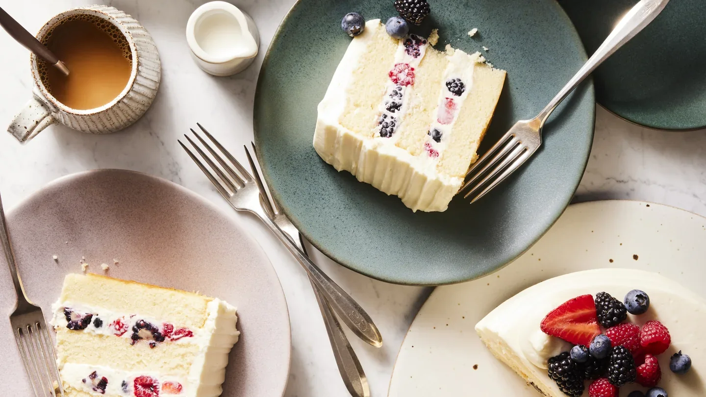 Slices of Whole Foods Berry Chantilly cake topped with berries