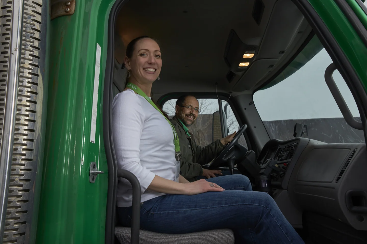 A volunteer and driver in the cab of a Second Harvest food-rescue truck