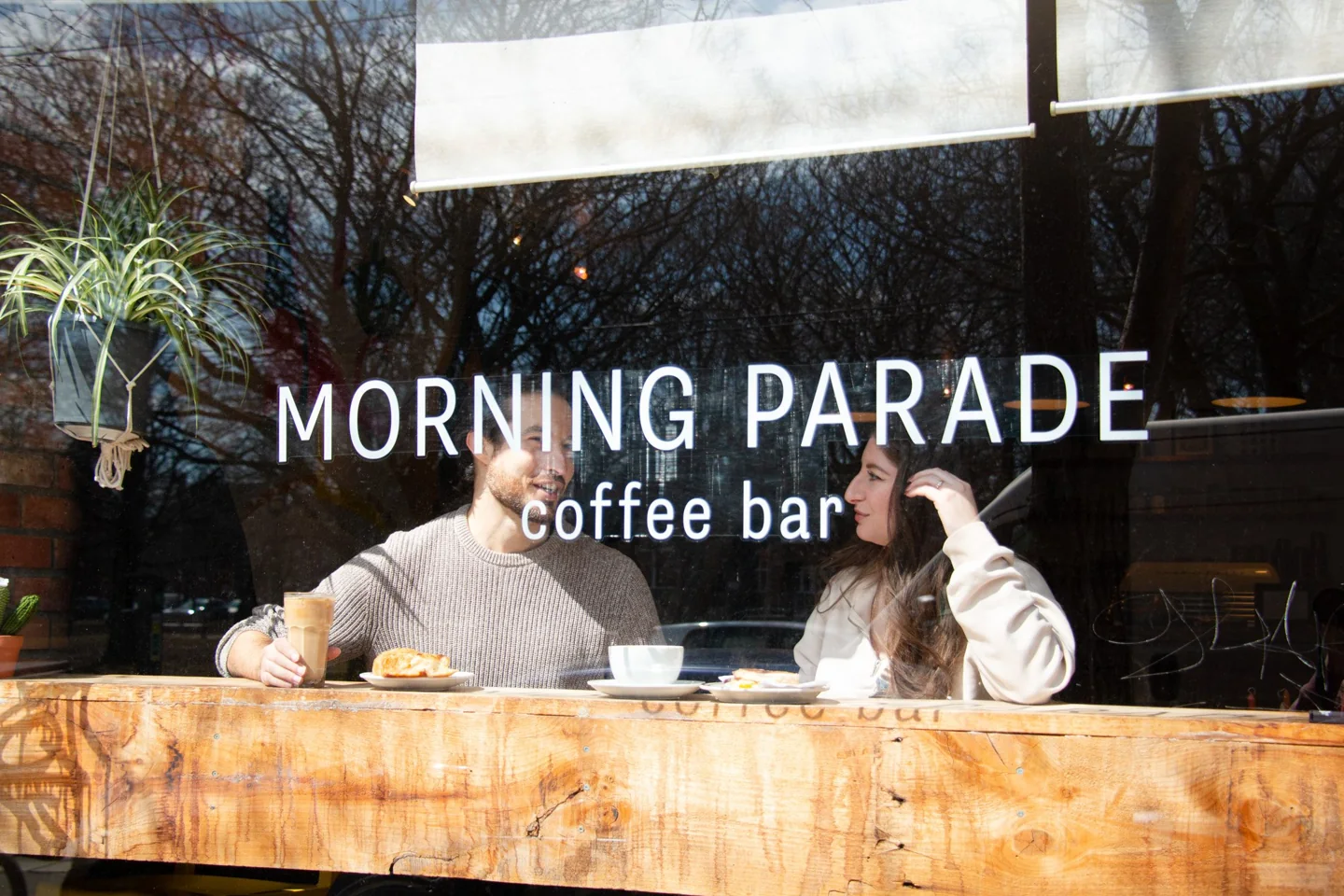 Two customers sit behind Morning Parade’s front window