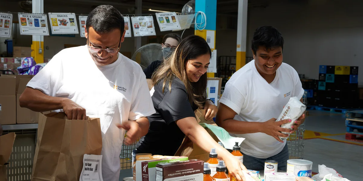 Volunteers sort food donations into boxes at Daily Bread Food Bank
