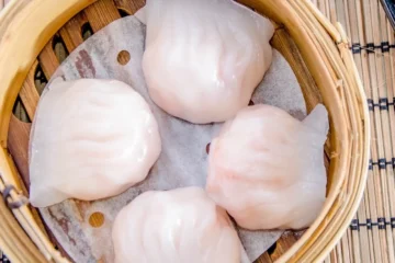 Shrimp dumplings in a bamboo steamer in Dim Sum King’s menu photograph