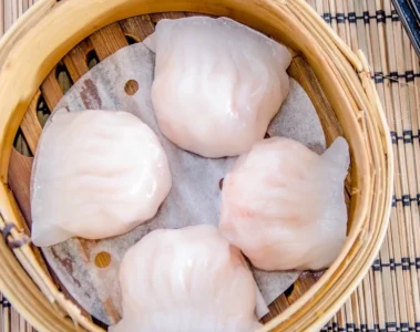Shrimp dumplings in a bamboo steamer in Dim Sum King’s menu photograph