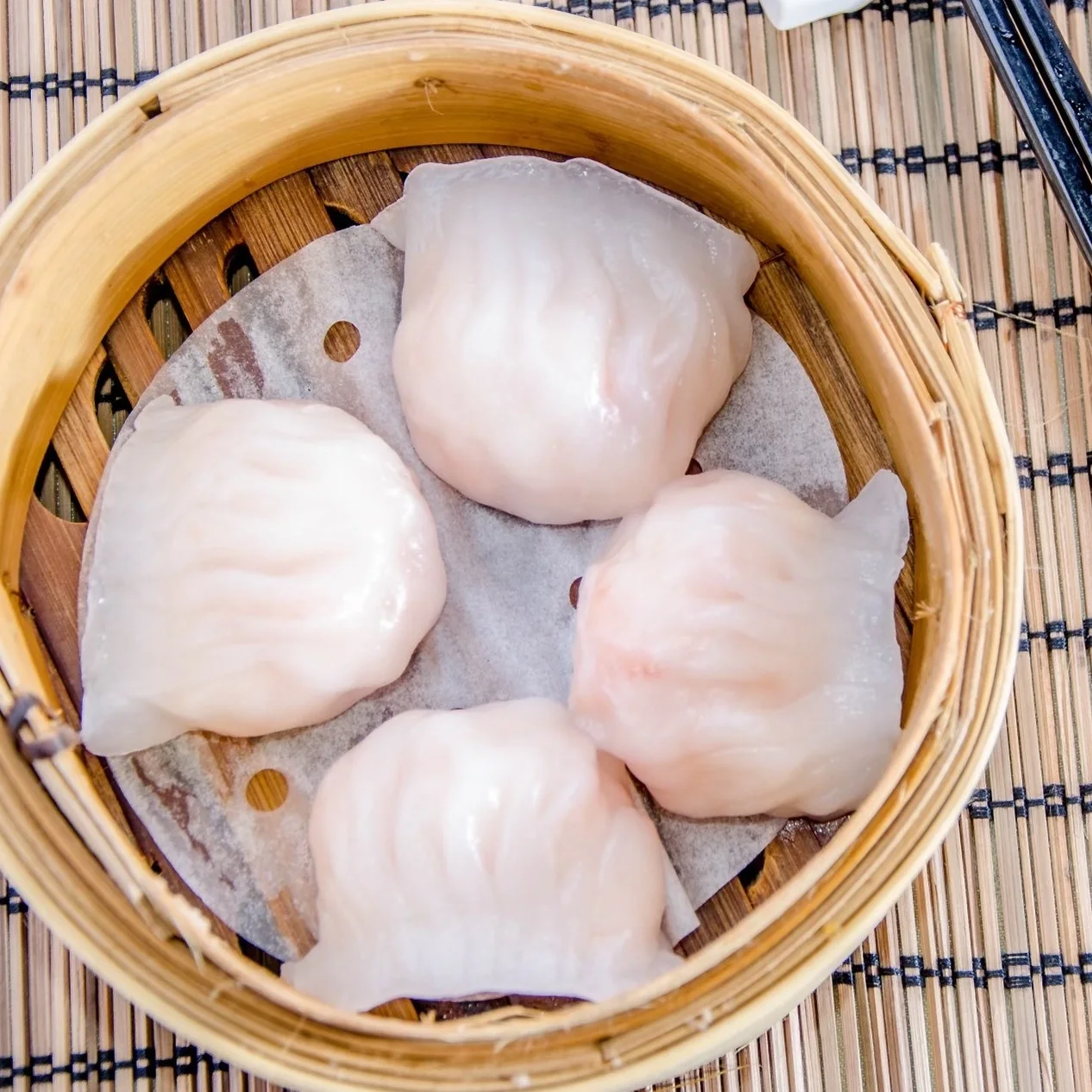 Shrimp dumplings in a bamboo steamer in Dim Sum King’s menu photograph