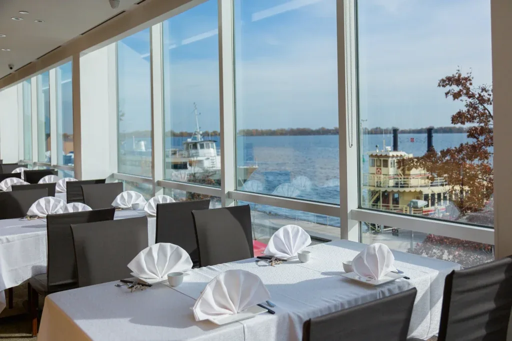 Tables beside harbour-facing windows at Pearl Harbourfront