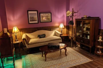 The purple-lit sitting room in Maryweather Mansion at Looking Glass Adventures