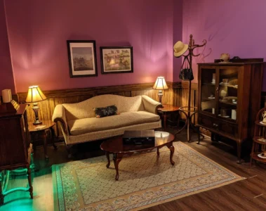 The purple-lit sitting room in Maryweather Mansion at Looking Glass Adventures