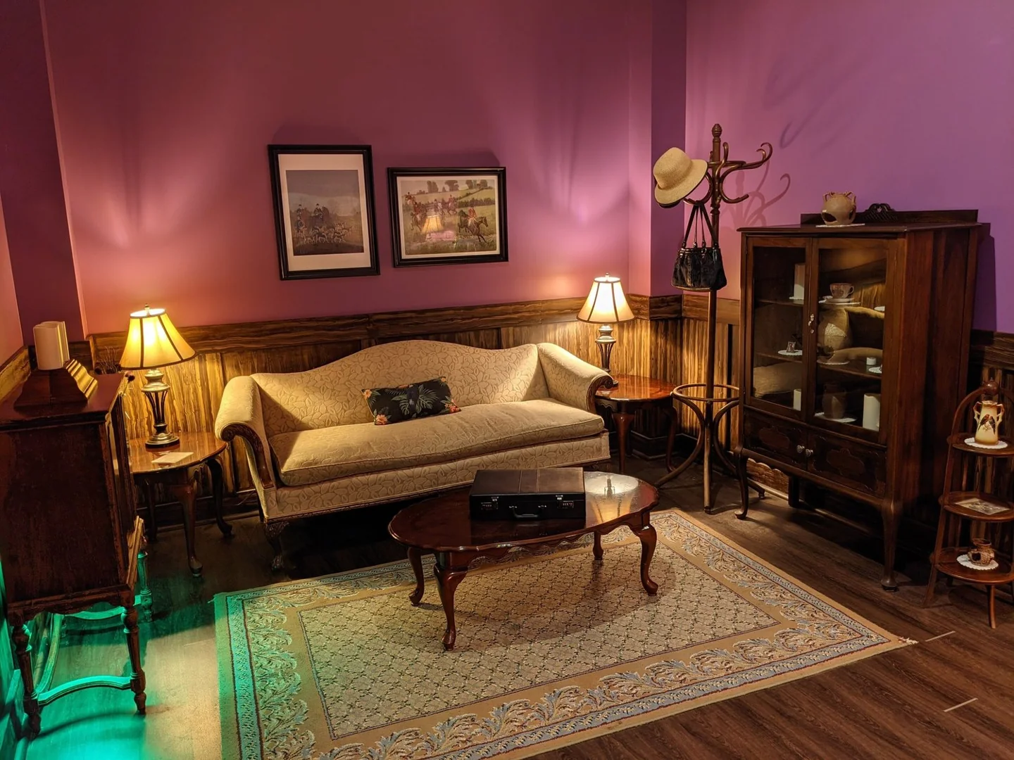 The purple-lit sitting room in Maryweather Mansion at Looking Glass Adventures