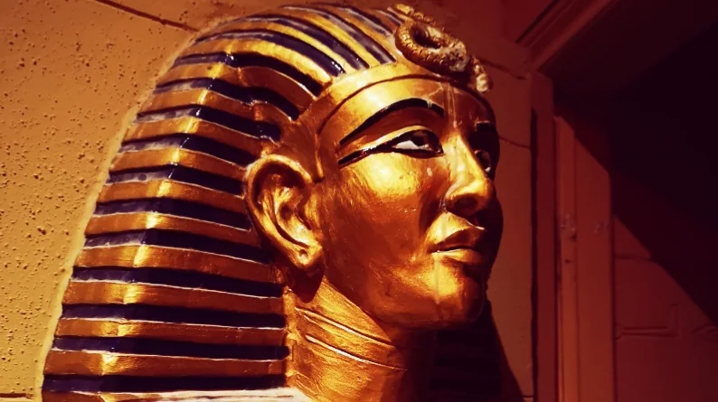 A gold Egyptian-style mask in a Roundabout Canada game room