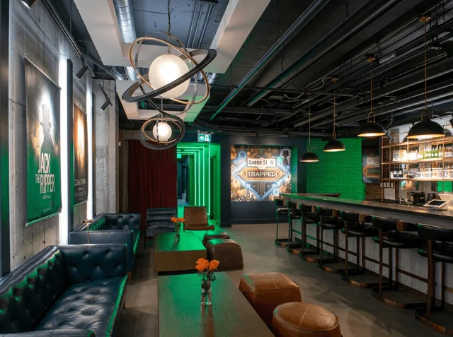 Sofas, a long counter and green lighting in Trapped’s Queen Street lobby