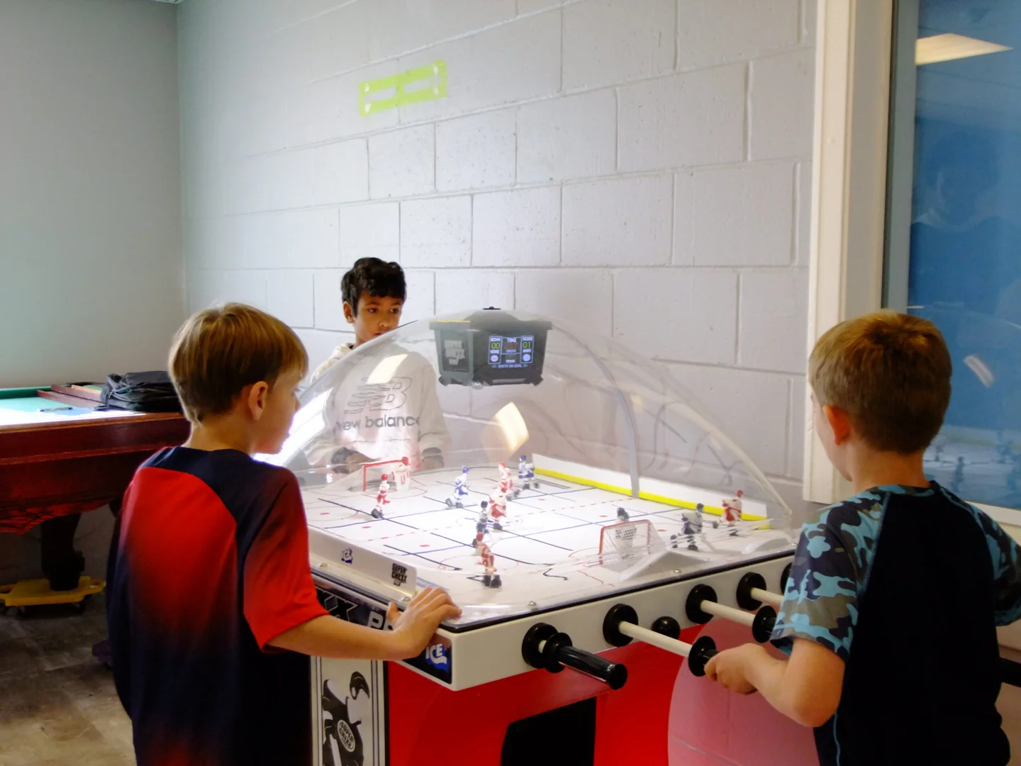 Children play table football in the Dovercourt games room