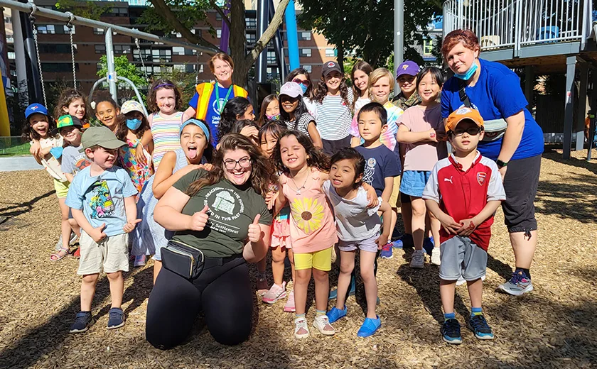 Children and camp staff gather outdoors