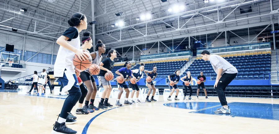 Young people take part in a basketball activity