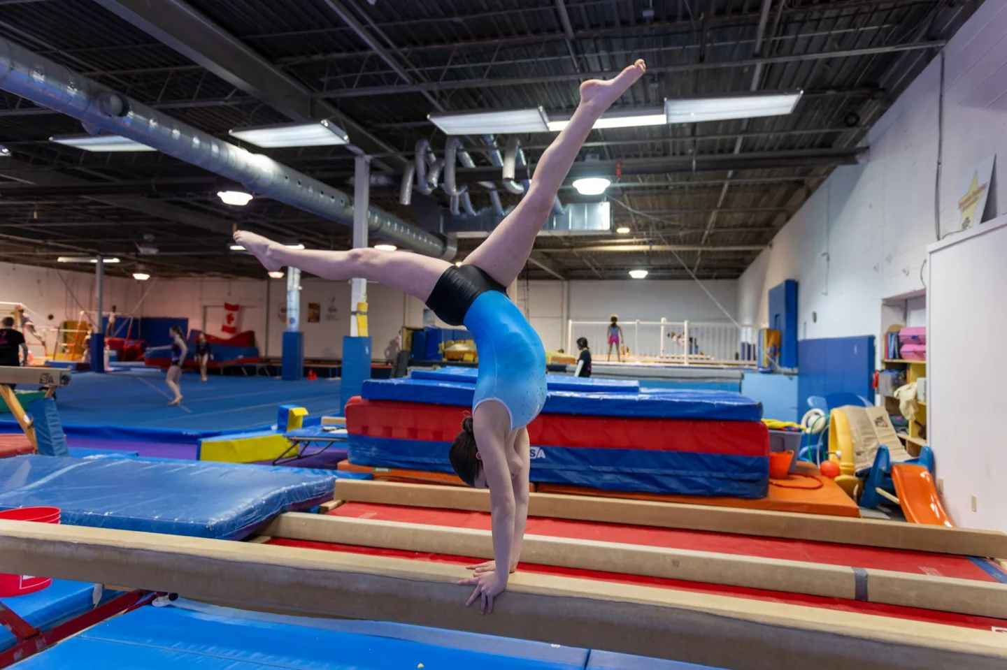 A gymnast practises on indoor equipment