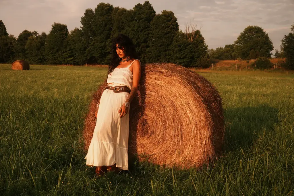 A model wears a light dress in an Exile Vintage clothing photograph