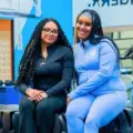 TMU students Cami Rabia and Abbygail Baker-Douglas sitting together in a workout room
