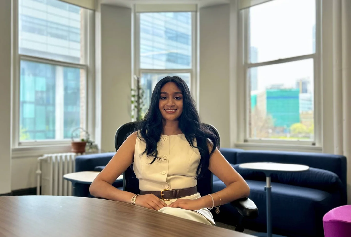 Avasa Sarawan sitting at a table in the Human Biology student lounge
