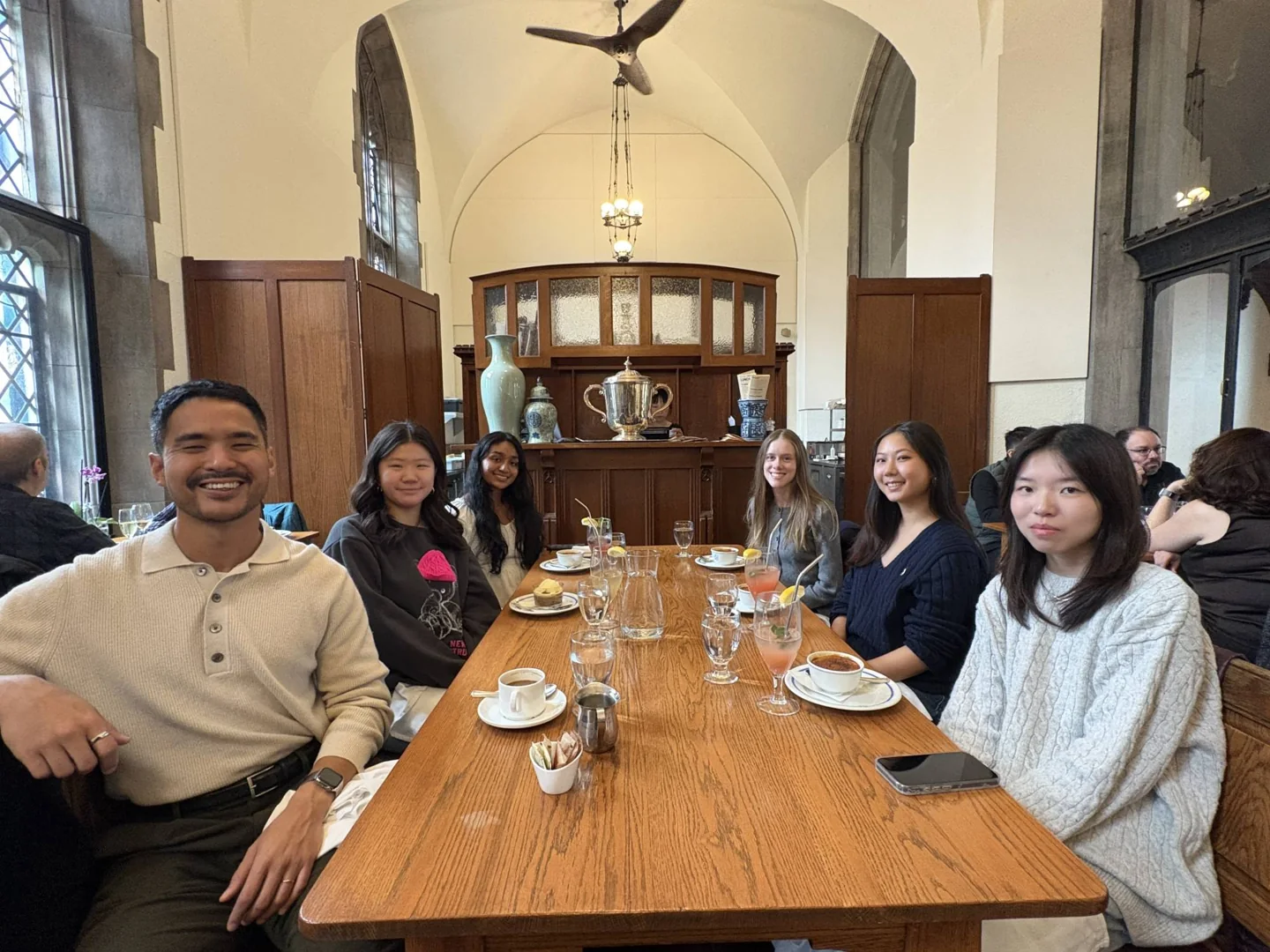 A University of Toronto class group sharing lunch at a table