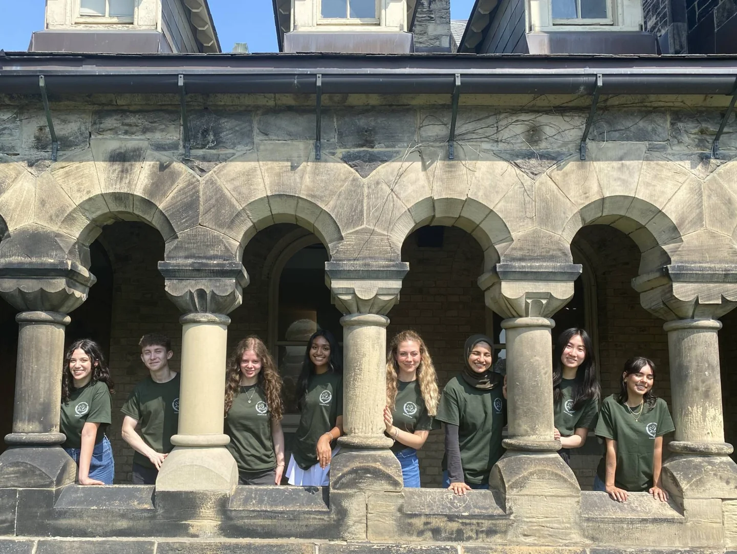 University College community assistants and coordinators together by brick columns