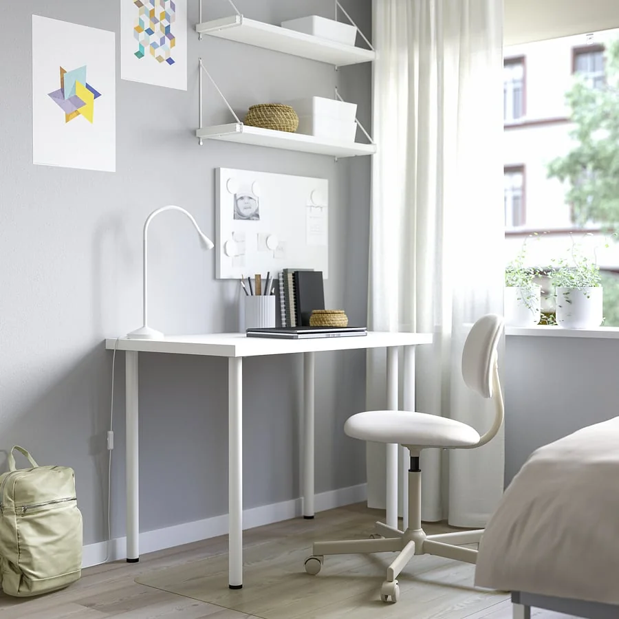 A compact desk beside a bright window
