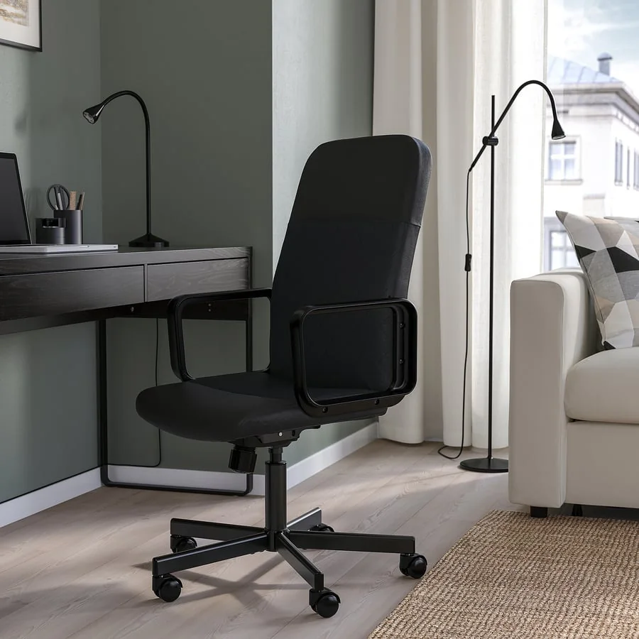 A black office chair at a desk