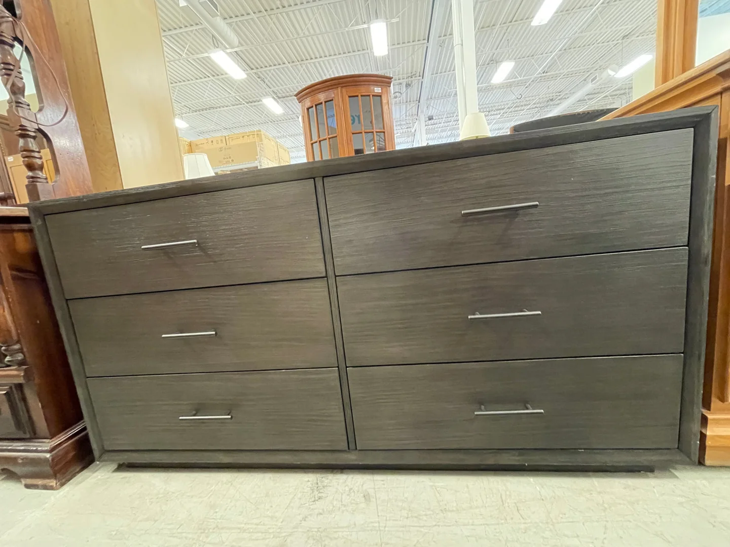 A used black wooden dresser