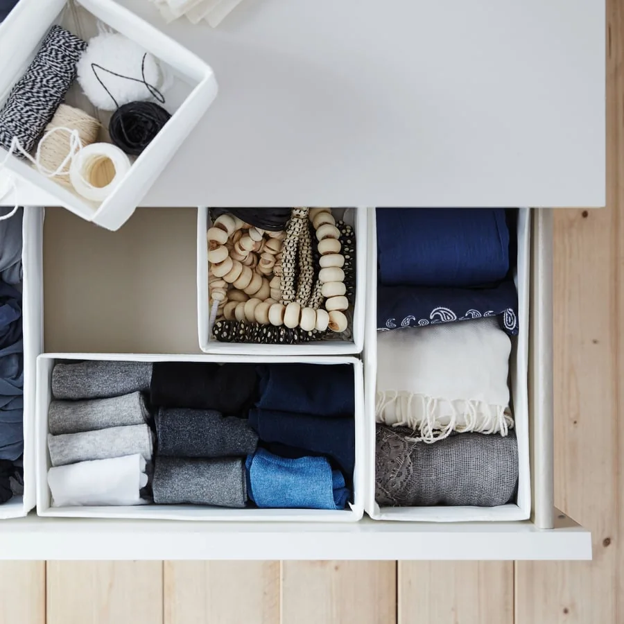 Small fabric boxes sorting clothes in a drawer