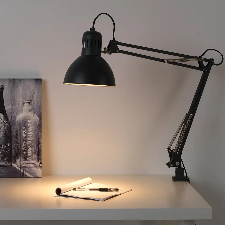 An adjustable reading lamp over a notebook
