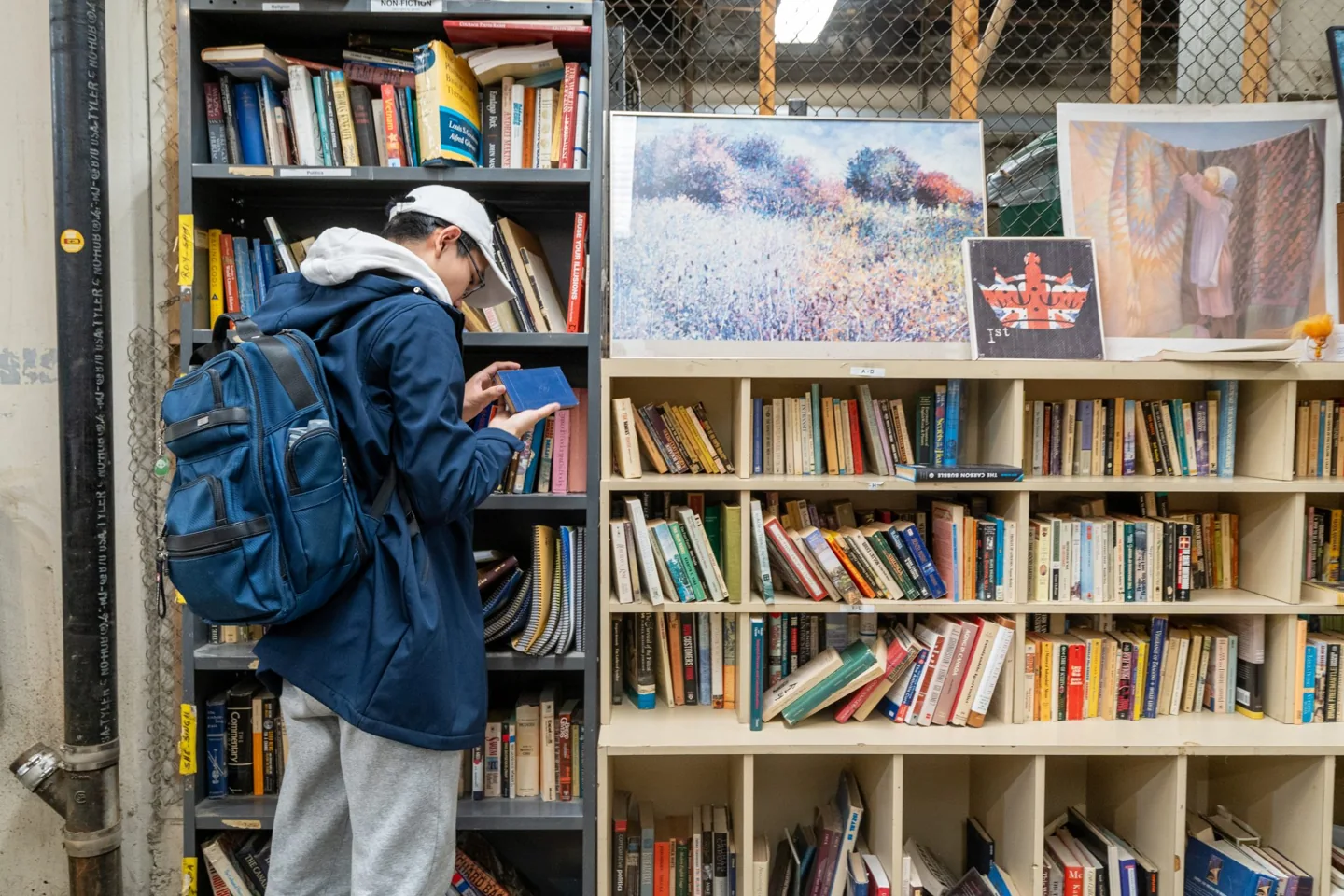 A shopper looking through books at the University of Toronto Free Store