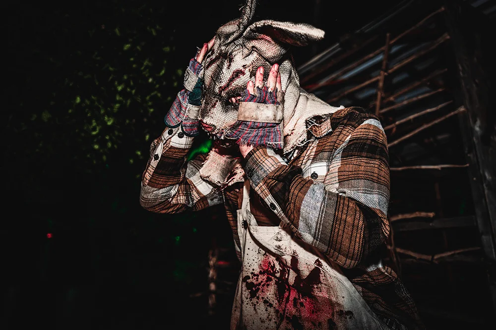 A masked performer in a plaid shirt at Bingemans Screampark