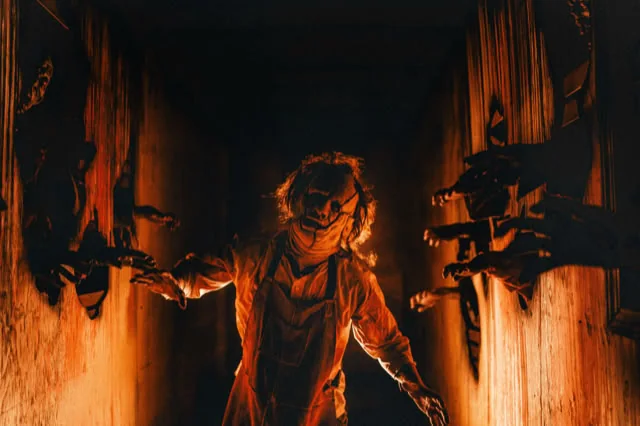 A scare character in a dim corridor at Fear Farm