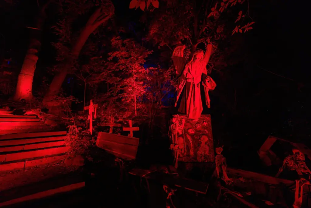 A red-lit outdoor scene among trees at Casa Loma