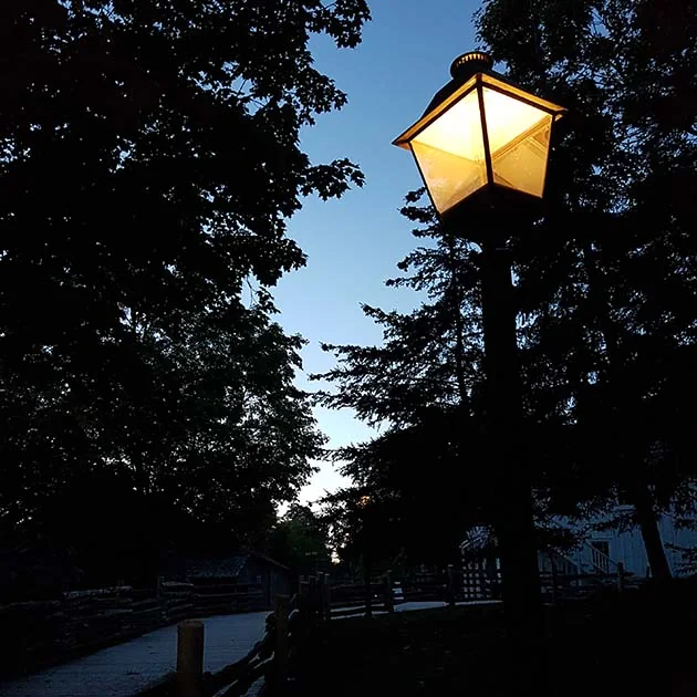 A lamp lights a path at the Village at Black Creek